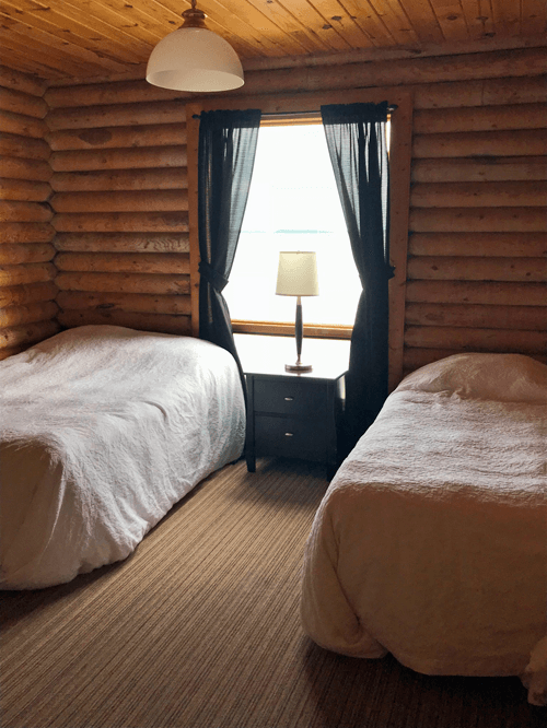 cabin-window Big Log Cabin double bedroom at Budd's Gunisao Lake Lodge World's Best Trophy Walleye and Northern Pike Fishing