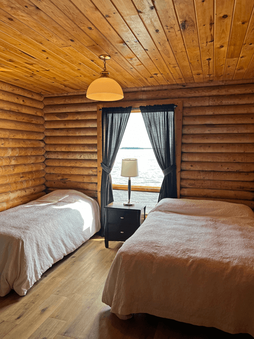 Big Log Cabin double bedroom at Budd's Gunisao Lake Lodge World's Best Trophy Walleye and Northern Pike Fishing